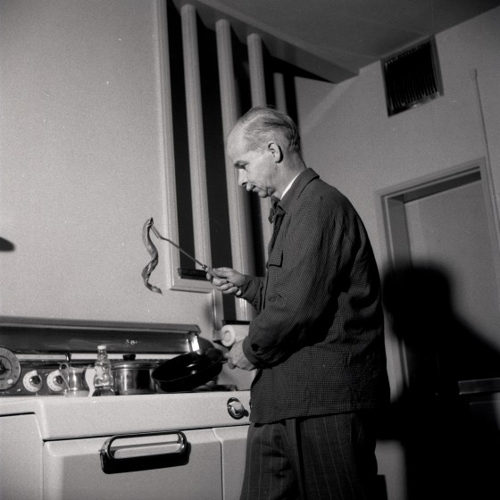 Dr. Robert Hatt cooking in Milles House.  1953, Cranbrook Archives. 