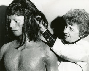 Betty Odle adjusts a wig on a Wayana figure, Aug 1969. Cranbrook Archives.
