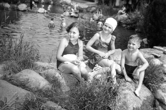 Children sitting on the rocks at Lake Jonah/Jonah Pools. Harvey Croze, photographer, Jul 1953.