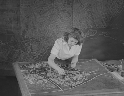 Alice Warren working on her city planning model for Plymouth, MI, 1944. Photographer, Harvey Croze. Courtesy Cranbrook Archives.